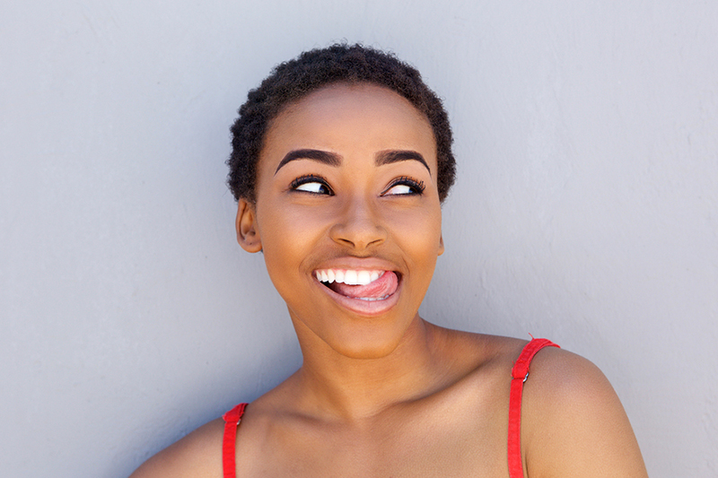 Happy Young Woman Sticking Tongue Out